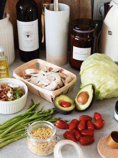 A variety of fresh ingredients and kitchen tools for preparing a healthy meal.